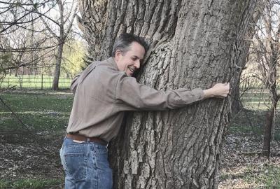 Man hugging large tree