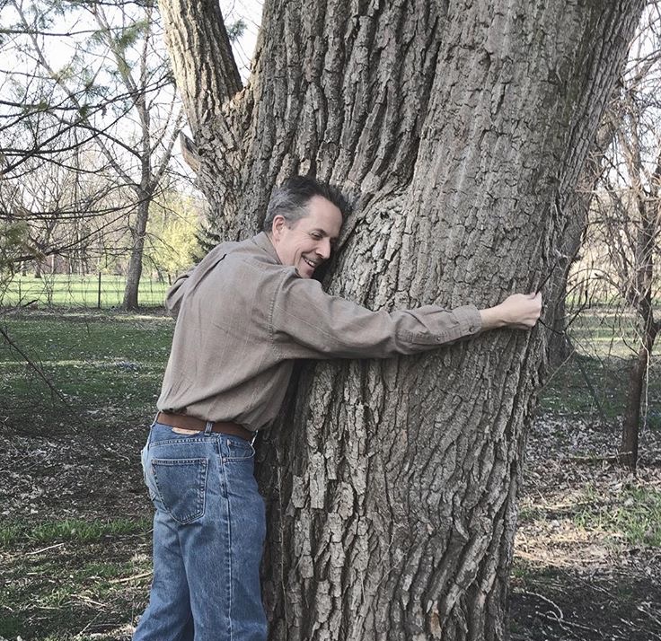 Man hugging large tree